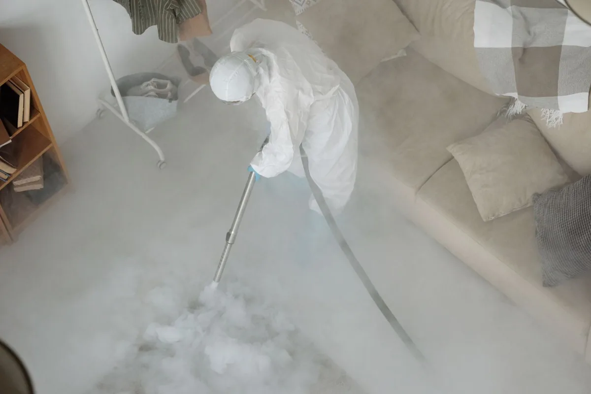 Biohazard cleanup technician in protective equipment, Riverside, PA
